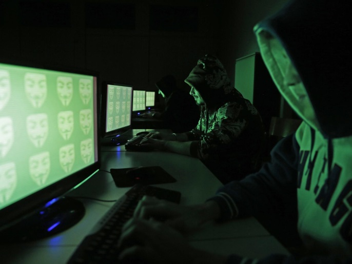 People pose in front of a display showing the word 'cyber' in binary code, in this picture illustration taken in Zenica December 27, 2014. A previously undisclosed hacking campaign against military targets in Israel and Europe is probably backed by a country that misused security-testing software to cover its tracks and enhance its capability, researchers said. Picture taken December 27, 2014. REUTERS/Dado Ruvic (BOSNIA AND HERZEGOVINA - Tags: SCIENCE TECHNOLOGY CRIME LAW)