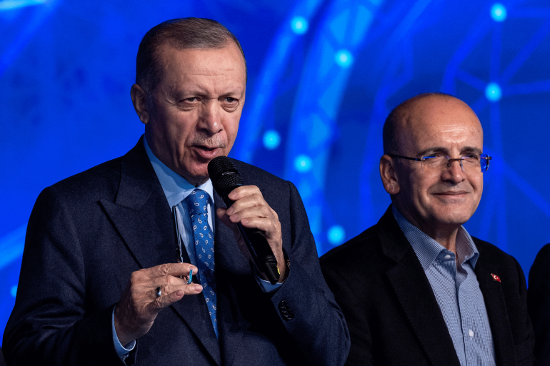 Turkish President Tayyip Erdogan attends a ceremony to mark an increase in capacity at a natural gas storage facility as he is flanked by former Deputy Prime Minister Mehmet Simsek and Energy Minister Fatih Donmez in Silivri near Istanbul, Turkey, December 16, 2022. REUTERS/Umit Bektas