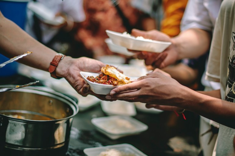 The help of volunteers helps to donate free food to the starving people.