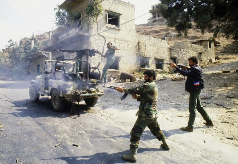 TOPSHOT - Pro-Syrian militiamen from Alawite Arab Democratic Party fight 29 September 1985 in Tripoli, northern Lebanon, against the pro-Arafat Sunni Moslem Fundamentalist of al-Tawheed Islamic Unification Movement for the control of the city and its port. The port was allegedly being used to distribute armaments and supplies to Arafat loyalists. Four weeks of intensive fighting between rival militias in Tripoli in September and October 1985 were interpreted as part of Syria's campaign to prevent the re-emergence in Lebanon of the pro-Arafat wing of the Palestine Liberation Organization. More than 500 people were killed and 500,000 were driven from their homes before a cease-fire was agreed in Damascus at the beginning of October 1985, and the Syrian army moved into the city; (Photo by NABIL ISMAIL / AFP) (Photo by NABIL ISMAIL/AFP via Getty Images)