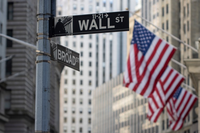 New York, NY, USA - July 4, 2022: The Wall Street sign is seen outside the New York Stock Exchange (NYSE) Building in the Financial District of Lower Manhattan in New York City.