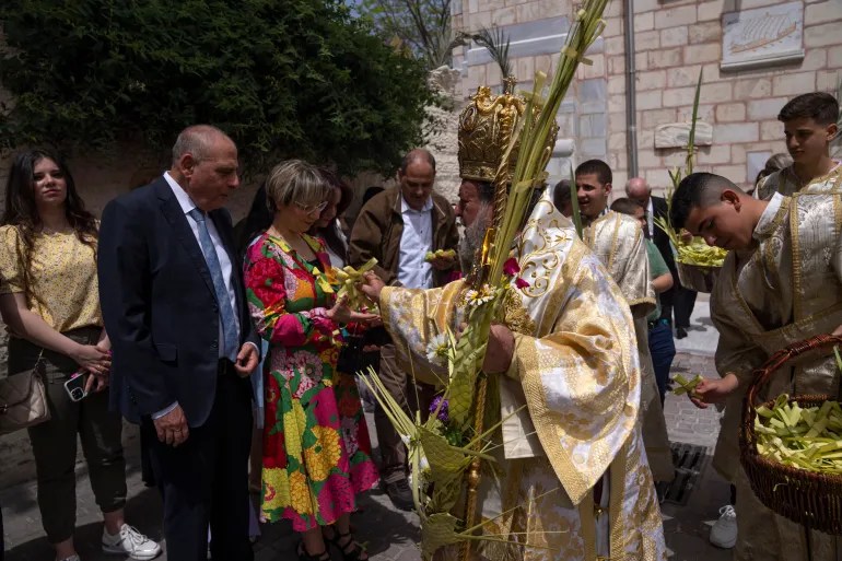 Palestinian Christians attend Palm Sunday mass at Saint Porphyrius Church in Gaza City on Sunday, April 9, 2023 – before the start of Israel’s war on Gaza [Fatima Shbair/AP]