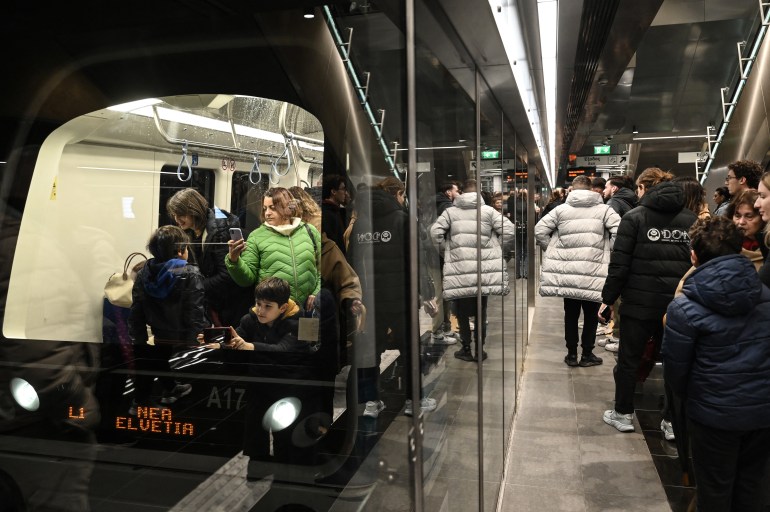 People take the train after the inauguration of the metro of Thessaloniki on November 30, 2024. - Greece's second city Thessaloniki unveil its new subway system more than a decade after the project was dogged by archaeological challenges and financial difficulties. (Photo by Sakis Mitrolidis / AFP)