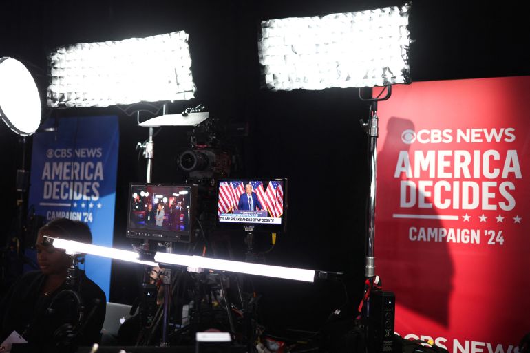 Former US president and Republican presidential nominee Donald Trump is seen on a screen in the spin room of the CBS studios in New York ahead of the vice presidential debate between US Senator and Republican vice presidential candidate J.D. Vance and Minnesota Governor and Democratic vice presidential candidate Tim Walz on October 1, 2024. (Photo by Charly TRIBALLEAU / AFP)