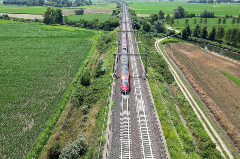 Europe, Italy , Milan - Frecciarossa Hight speed 300km h train railway from Milan to Rome view from the drone - the faster way to travel in Italy for tourist and passengers - tourist destination ; Shutterstock ID 2494617527; purchase_order: aljazeera ; job: ; client: ; other: