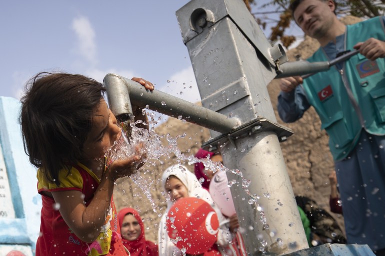 KABUL, AFGHANISTAN - OCTOBER 31: A child drinks water from the water-well in Kabul, Afghanistan on October 31, 2022 as it is voluntarily established by an NGO, the Cansuyu Charity and Solidarity Organization. 14 water-wells have been set up in 14 regions where have water problem due to drought. (Photo by Muhammed Abdullah Kurtar/Anadolu Agency via Getty Images)