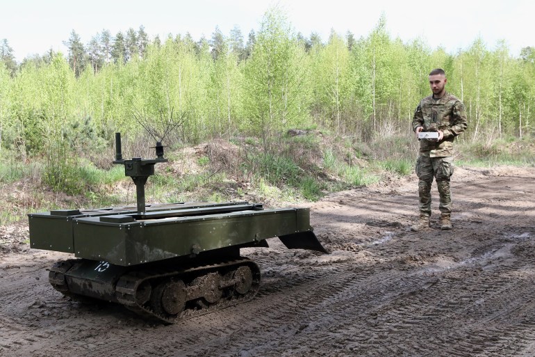 ZHYTOMYR REGION, UKRAINE - APRIL 23, 2024 - A serviceman stands before the VEPR ground logistics robotic complex during drills of the Liut (Fury) Brigade of the National Police of Ukraine at a training area in Zhytomyr region, northern Ukraine. (Photo credit should read Volodymyr Tarasov / Ukrinform/Future Publishing via Getty Images)