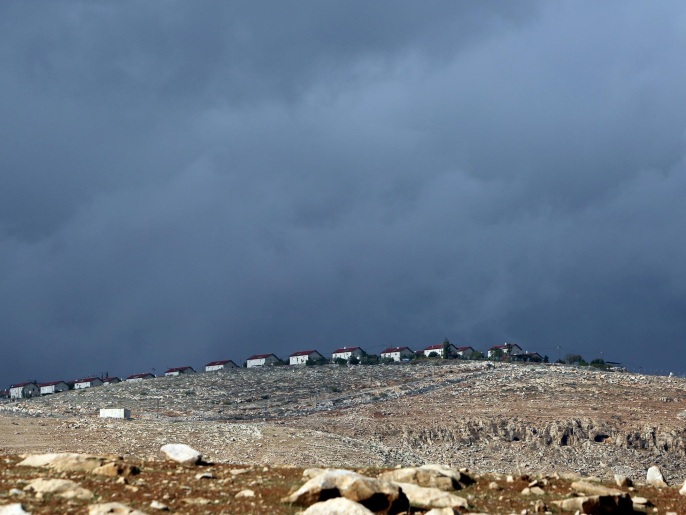 Storm clouds move over an Israeli settlement in the Jordan Valley on November 27, 2014. A fierce winter storm has battered the region since Monday and the United Nations declared an emergency in Gaza City following the extreme weather and flooding. AFP PHOTO / ABBAS MOMANI