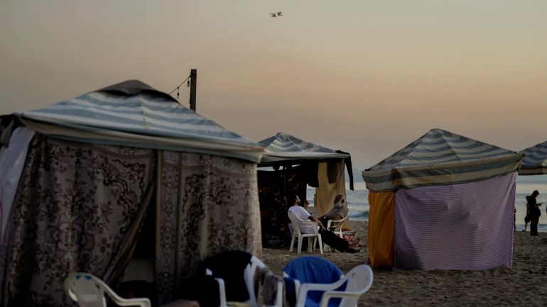 Tents set up as temporary shelters by displaced families fleeing Israeli air strikes, along the Ramlet al-Baida public beach in Beirut on October 8, 2024 [Bilal Hussein/AP Photo]