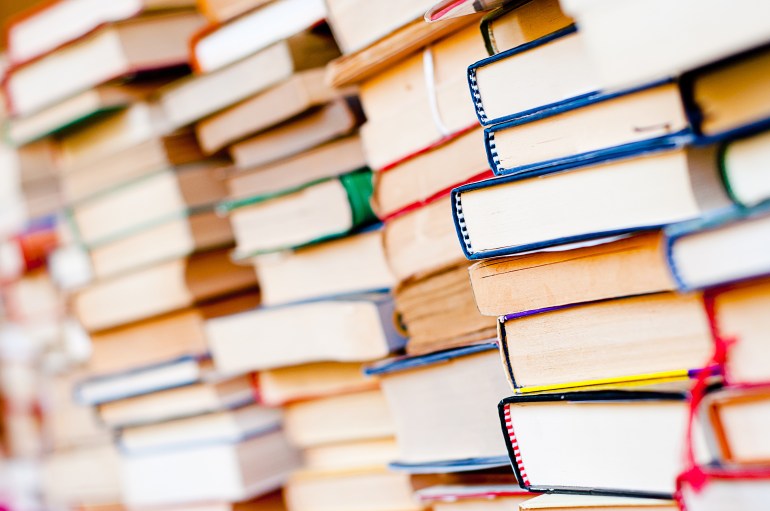 Stack of books background. many books piles.