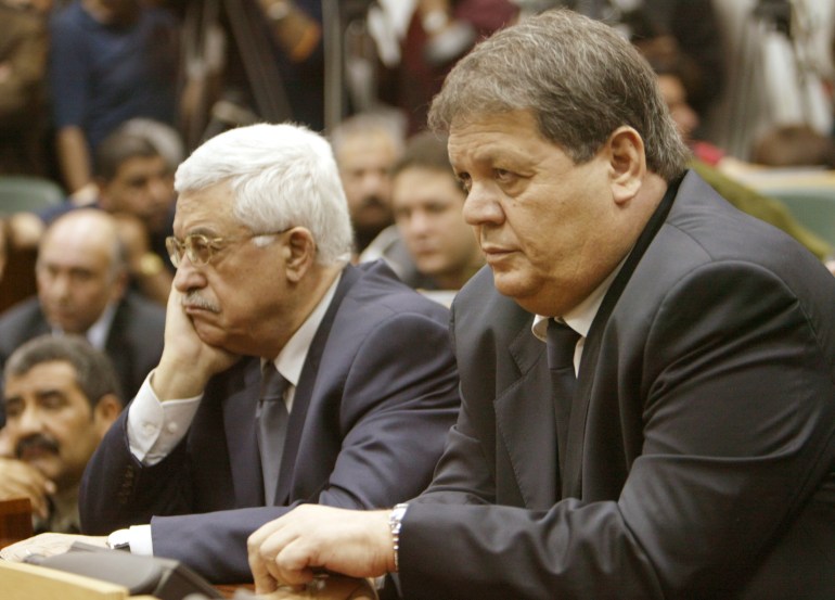 Mahmoud Abbas (L), the newly elected chairman of the Palestine Liberation Organisation and Rawhi Fattouh, the new interim president of the governing Palestinian Authority, attend a session of the Palestinian Parliament in the West Bank city of Ramallah November 11, 2004. Palestinians moved swiftly to establish a collective leadership on Thursday and avert a power vacuum after Yasser Arafat's death, handing top positions to moderates and hardliners alike. REUTERS/Ammar Awad RKR/DL