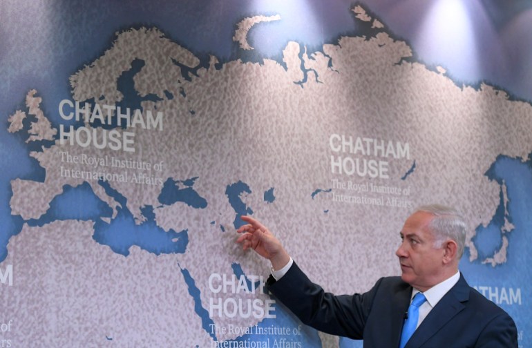 Israel's Prime Minister Benjamin Netanyahu gestures towards a world map as he attends a question and answer event on Israel's foreign policy at Chatham House in London, Britain, November 3, 2017. REUTERS/Toby Melville