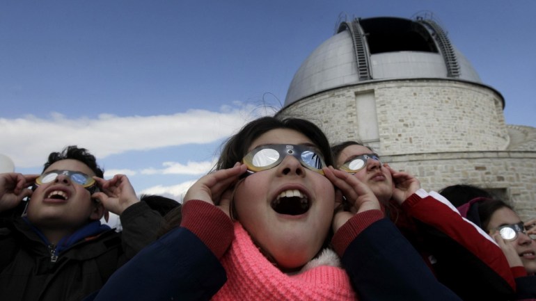 Children look at the solar eclipse through special glasses at the Observatory of Penteli, in Athens, Greece, 20 March 2015. A Partial Solar Eclipse is seen in Europe, northern and eastern Asia and northern and western Africa on 20 March with the eclipse starting at 07:41 UTC and ending at 11:50 UTC