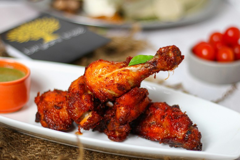 Close-Up Shot of Delicious Fried Chicken on White Ceramic Plate