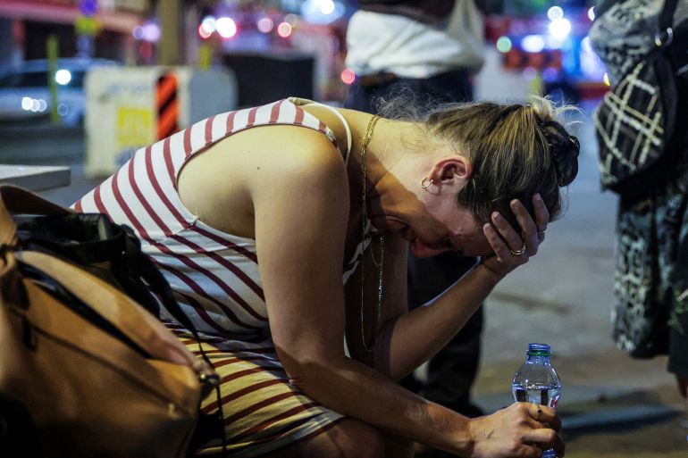 A woman reacts at the site where a rocket launched from the Gaza Strip landed in Tel Aviv, Israel October 7, 2023. REUTERS/Itai Ron ISRAEL OUT. NO COMMERCIAL OR EDITORIAL SALES IN ISRAEL