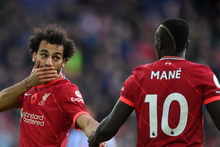 Mohamed Salah of Liverpool talks with team mate Sadio Mane during the Premier League match between Liverpool and Brighton & Hove Albion at Anfield on October 30, 2021 in Liverpool, England. (Photo by Shaun Botterill/Getty Images)