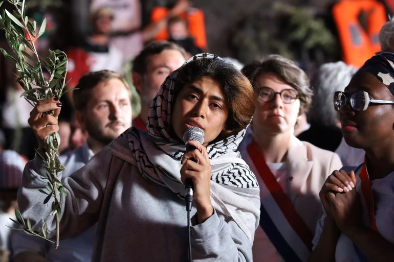 PARIS, FRANCE - JUNE 12: French-Palestinian lawyer and European Parliament member representing France's La France Insoumise (LFI) party, Rima Hassan, attends a demonstration held in her support at Place de la Republique in Paris on June 12, 2025. The rally was organized following her deportation after being detained by Israeli authorities along with other activists aboard a humanitarian vessel bound for Gaza. (Photo by Ameer Alhalbi/Anadolu via Getty Images)
