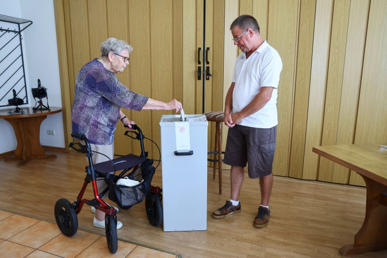 A woman casts her vote in the Thuringia state election, in Bornhagen, Germany, September 1, 2024. REUTERS/Wolfgang Rattay