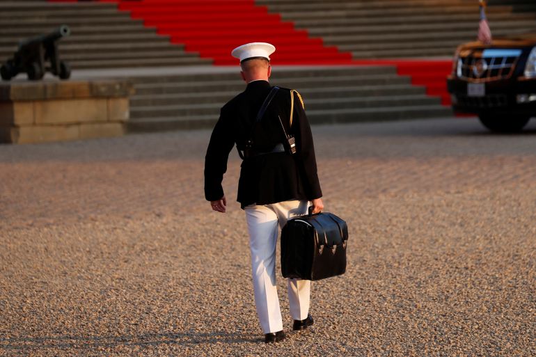 A military aide carries the "football" containing launch codes for nuclear weapons into Blenheim Palace, where U.S. President Donald Trump and first lady Melania Trump were dining, in Woodstock, Britain, July 12, 2018. REUTERS/Kevin Lamarque