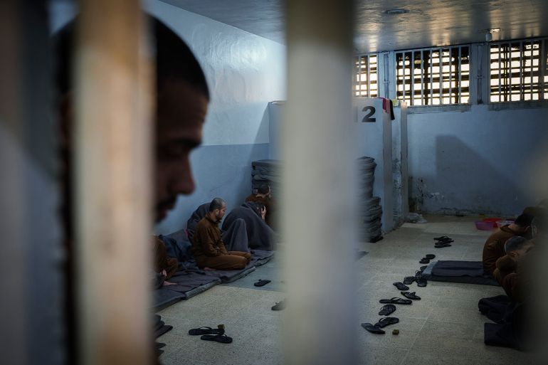 Inmates accused of being an Islamic State (ISIS) fighters sit inside a cell at the Syrian Democratic Forces-run Gweiran Prison, now called Panorama, in Hassakeh, northeastern Syria, Friday, Jan. 31, 2025. (AP Photo/Bernat Armangue)