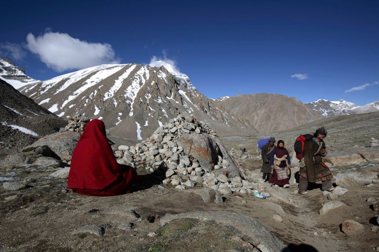 PURANG COUNTY, CHINA - JUNE 16: (CHINA OUT) A nun from Nepal worships the snow-capped Kangrinboqe Mountain, known as Mt. Kailash in the West, June 16, 2007 in Purang County of Tibet Autonomous Region, China. Kangrinboqe, meaning "the holy mountain" in Tibetan, is the summit of Gangdise Mountains with an altitude around 6,638 meters (21,778 feet) above sea-level. It is considered a sacred place in four religions, Hinduism, Buddhism, Jainism and Bon faith. Every year, thousands of pilgrims, including Tibetans, overseas religious devotees from India, Nepal and Bhutan, make pilgrimages to Kangrinboqe, following a tradition dating back thousands of years. Some of pilgrims take a year or longer to reach the sacred mountain. (Photo by China Photos/Getty Images)